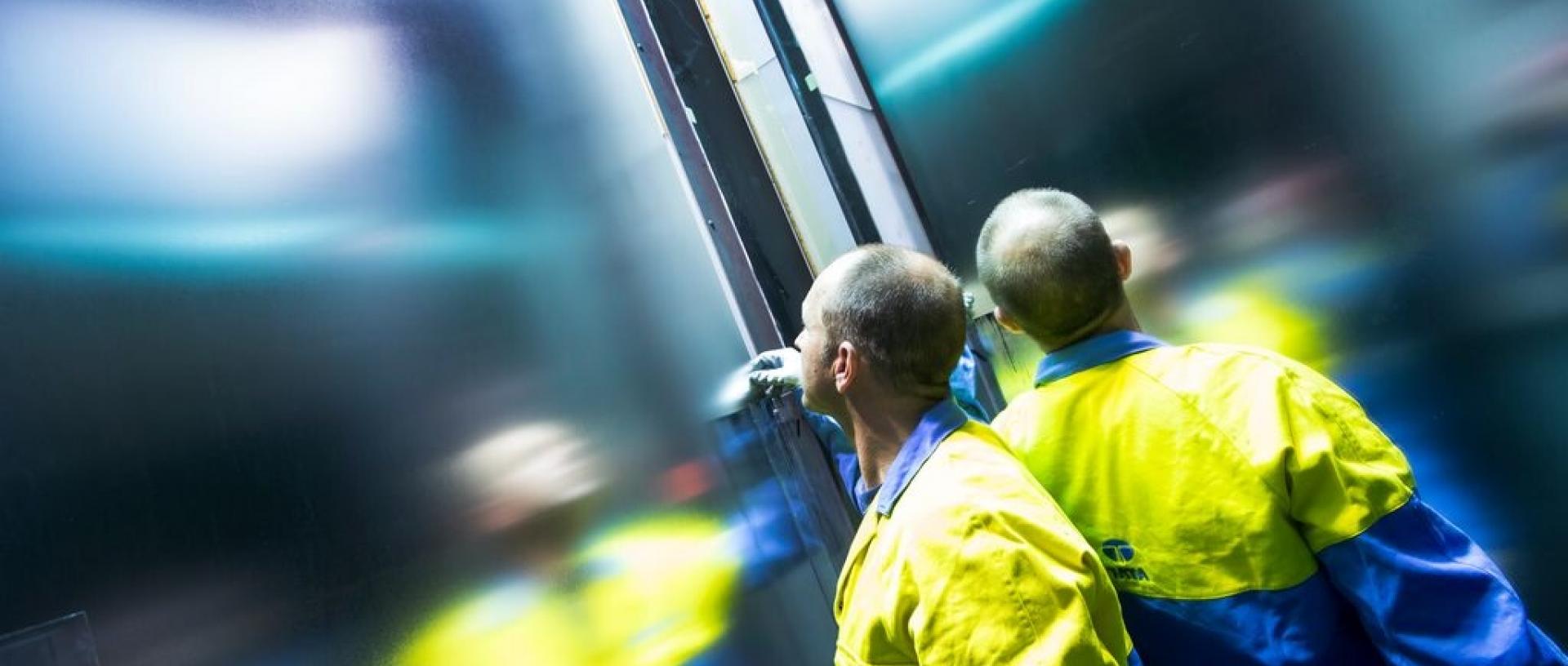 Tata Steel employee in high viz jacket checking steel