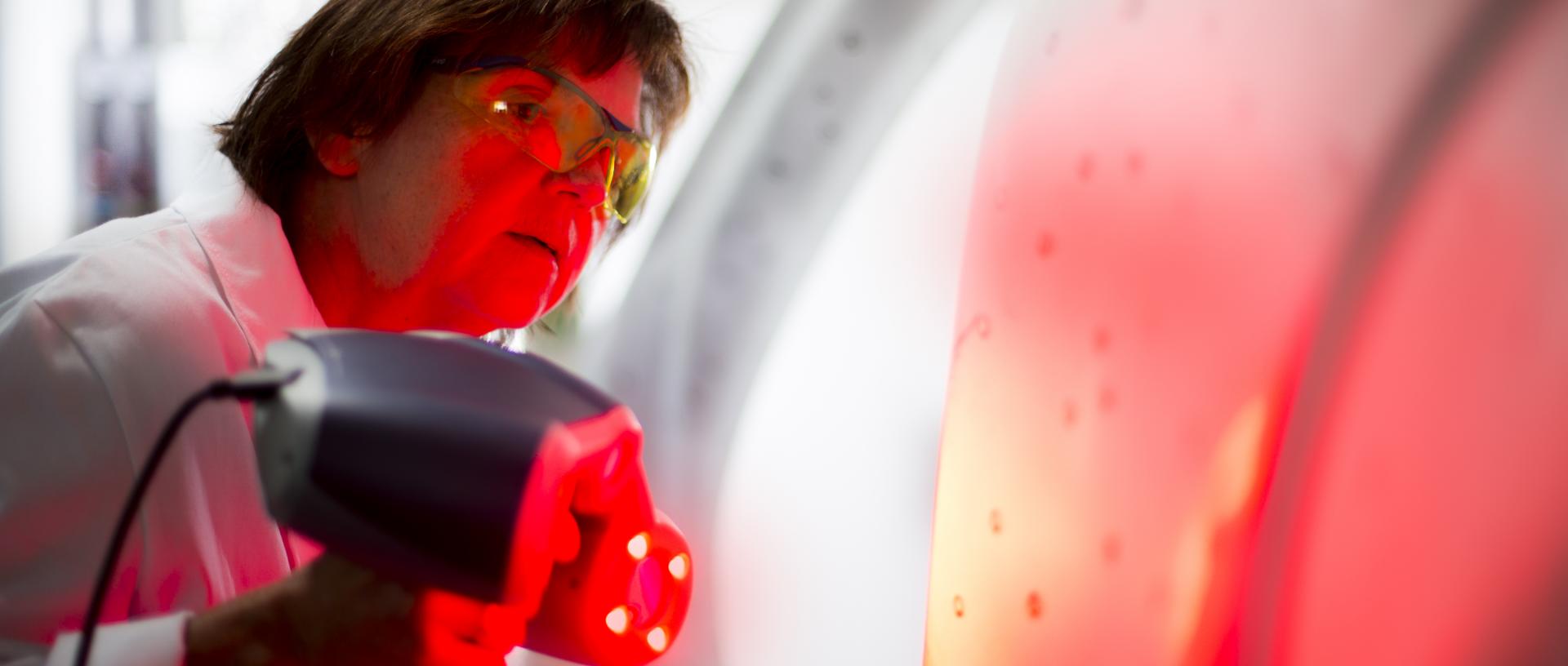 Technician scanning an automotive body panel