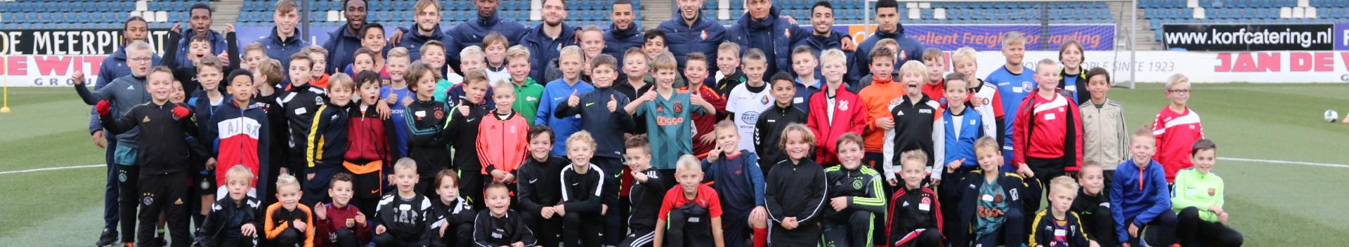 Group of kids on a playing field at Tata Kids of Steel football clinic