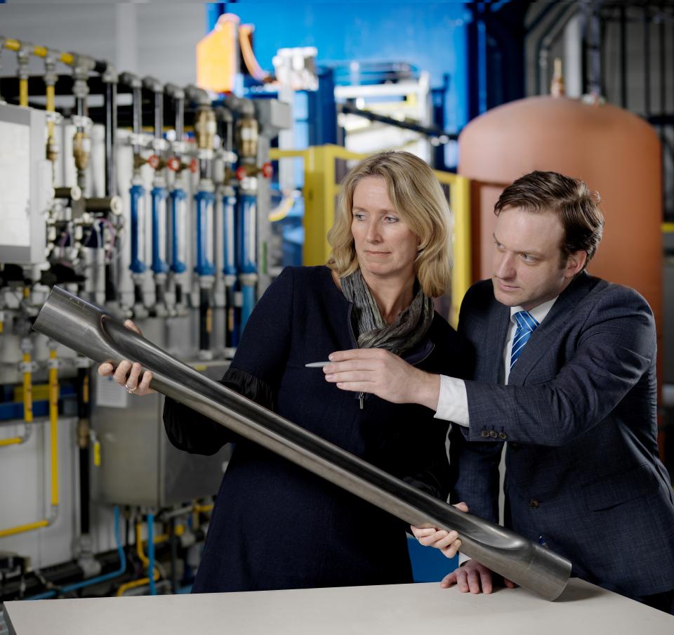 Business colleagues examining a chassis part